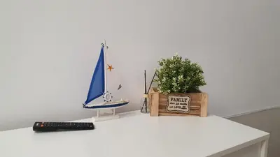 a white table with a toy sailboat and a plant at Peset 69 in Valencia