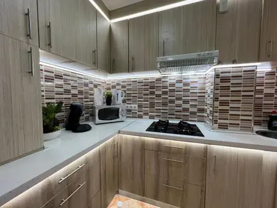 a kitchen with wooden cabinets and a stove top oven at Peset 69 in Valencia