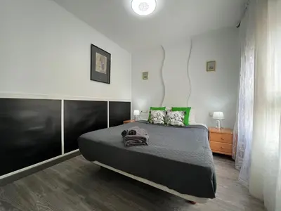 a bedroom with a large bed with green pillows at Peset 69 in Valencia