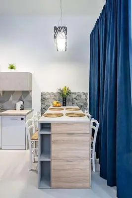 a kitchen with a table and a blue curtain at Fantastic Loft with an exquisite design in Valencia