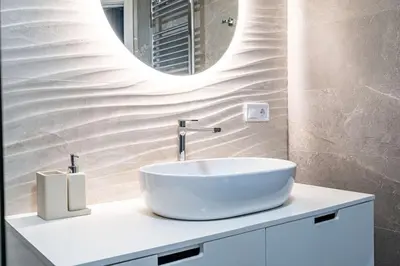 a bathroom with a white sink and a mirror at Fantastic Loft with an exquisite design in Valencia