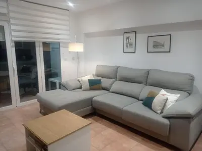 a living room with a couch and a table at Beach Nice Flat in Playa Pobla de Farnals