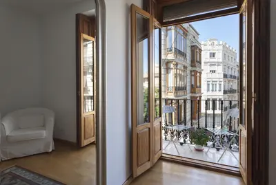 an open door to a balcony with a view of a city at Torres de Serranos Apartments - TTdSSa VLC in Valencia