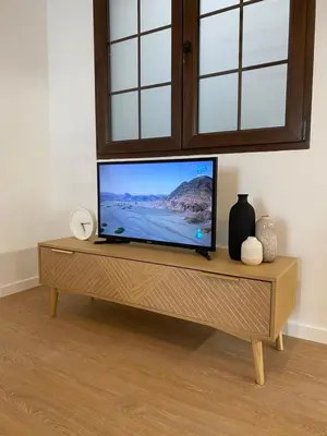 a flat screen tv sitting on top of a wooden table at RIZADA RUZAFA in Valencia