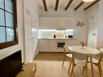 a kitchen and dining room with a table and chairs at RIZADA RUZAFA in Valencia