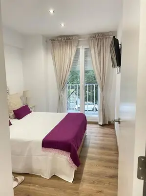 a bedroom with a large bed and a window at centrico cerca al ayuntamiento+luminoso+acogedor in Valencia