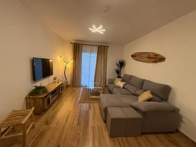 a living room with a couch and a flat screen tv at Vista Golf in Valencia