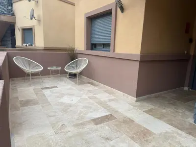 two chairs and a table in front of a building at Vista Golf in Valencia