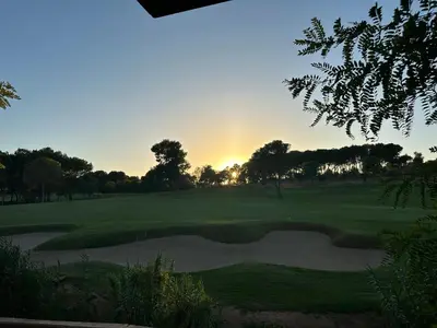 a view of a golf course with the sunset in the background at Vista Golf in Valencia