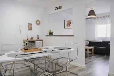 a kitchen and living room with a table and chairs at El Camino Del Mar in Valencia