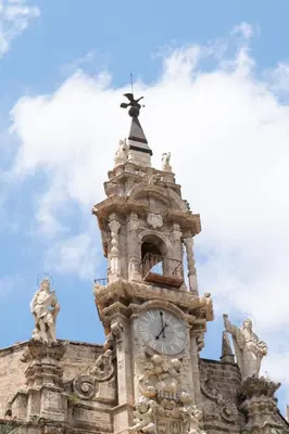 a clock tower with a cross on top of it at El Camino Del Mar in Valencia