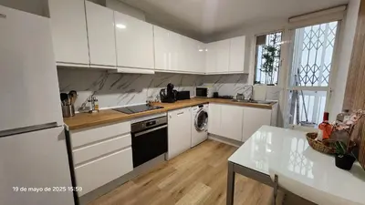 a kitchen with white cabinets and a sink and a dishwasher at Cervantes Prime in Valencia
