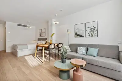 a living room with a couch and a table at Limehome Valencia Carrer del Pare Palau i Quer in Valencia