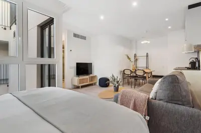 a living room with a couch and a tv at Limehome Valencia Carrer del Pare Palau i Quer in Valencia