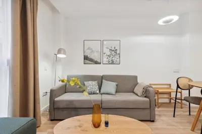a living room with a couch and a table at Limehome Valencia Carrer del Pare Palau i Quer in Valencia