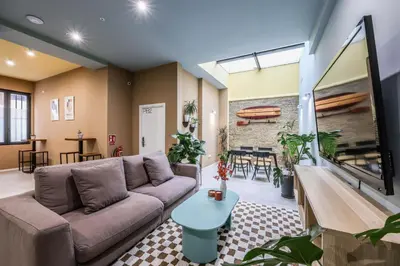 a living room with a couch and a table at Amazinn Valencia Cabanyal 2C in Valencia