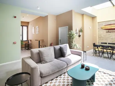 a living room with a couch and a table at Amazinn Valencia Cabañal 3A in Valencia