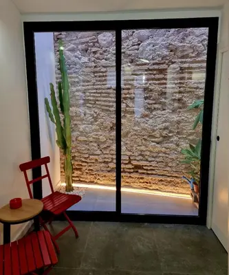 a room with a large window with a cactus at cactus loft Ruzafa in Valencia