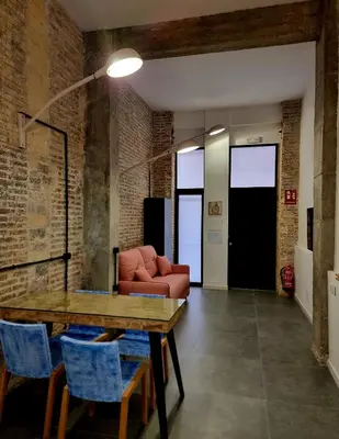 a living room with a table and a couch at cactus loft Ruzafa in Valencia