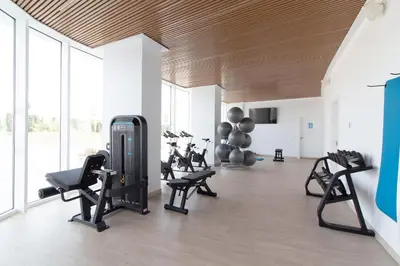 a gym with treadmills and exercise equipment in a room at Moderno apartamento con 2 terrazas en Gran Canet by Global Vacacional in Canet de Berenguer