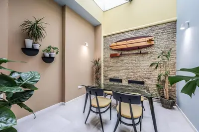 a room with a brick wall and a table and chairs at AmazINN Valencia Cabanyal 3D in Valencia