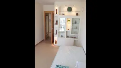 a room with a white wall with a shelf at Modern Penthouse-duplex Facing The Sea in La Torre