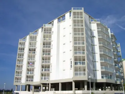 a tall white building with a blue sky in the background at Modern Penthouse-duplex Facing The Sea in La Torre