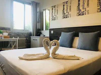 two towel swans sitting on top of a bed at VALENCIA SUITS YOU Centro Histórico, Establecimiento Automatizado-Fast Auto Check in&Out, Solo para Adultos-Adults only in Valencia
