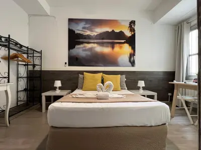 a bedroom with a bed with a large painting on the wall at VALENCIA SUITS YOU Centro Histórico, Establecimiento Automatizado-Fast Auto Check in&Out, Solo para Adultos-Adults only in Valencia