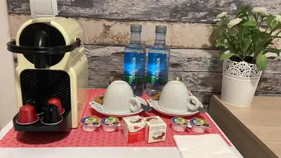 a table with a coffee maker and two bottles of water at VALENCIA SUITS YOU Centro Histórico, Establecimiento Automatizado-Fast Auto Check in&Out, Solo para Adultos-Adults only in Valencia