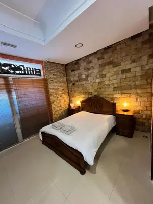 a bedroom with a large bed and a brick wall at IY Loft 5 - Spacious Loft in the Old Town in Valencia