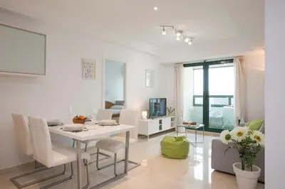 a white living room with a table and a dining room at SingularStays Alameda II in Valencia