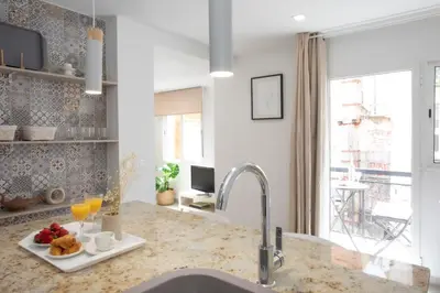a kitchen with a sink with a plate of food on a counter at SingularStays Guillem Sorolla in Valencia