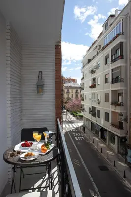 a balcony with a table with food and drinks on it at SingularStays Guillem Sorolla in Valencia