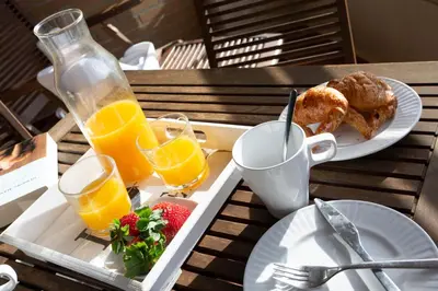 a tray with breakfast foods and drinks on a table at SingularStays Palacio de Congresos in Valencia