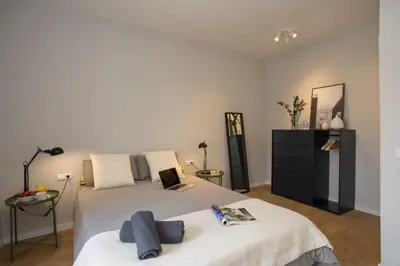 a bedroom with a bed with a laptop on it at SingularStays Quevedo II in Valencia