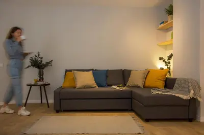 a woman standing in a living room with a couch at SingularStays Quevedo II in Valencia