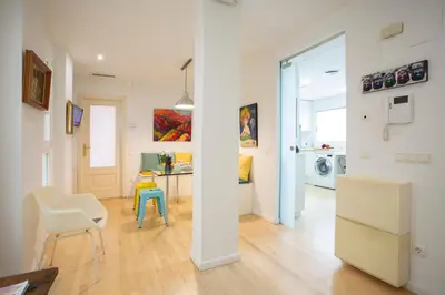 a living room with a kitchen and a dining room at SingularStays Reina II in Valencia