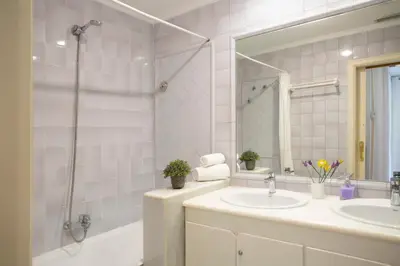 a bathroom with two sinks and a shower at SingularStays Reina II in Valencia