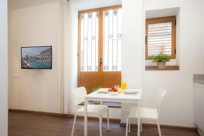 a white dining room with a white table and chairs at SingularStays Salvador II in Valencia