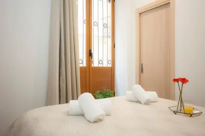 a bedroom with a bed with white pillows on it at SingularStays Salvador II in Valencia
