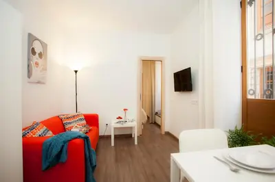 a living room with a red couch and a table at SingularStays Salvador II in Valencia
