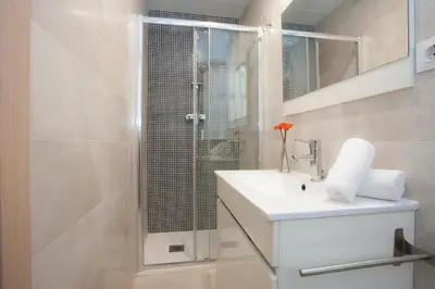a bathroom with a sink and a glass shower at SingularStays Salvador II in Valencia