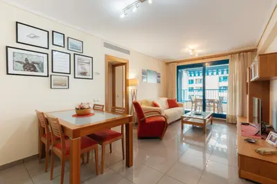 a living room with a table and a couch at RESORT BEACH VALENCIA in Valencia