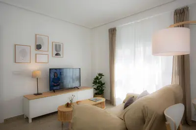a living room with a couch and a tv at SingularStays Campanar in Valencia