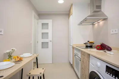 a kitchen with white walls and a stove top oven at SingularStays Campanar in Valencia