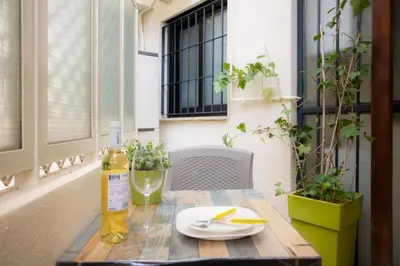 a table with a plate of food on a balcony at SingularStays Clero in Valencia