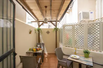a balcony with tables and chairs in a building at SingularStays Clero in Valencia