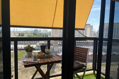 a table with a plate of food on a balcony at SingularStays Oceanografico II in Valencia