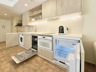 a kitchen with an open refrigerator and a dishwasher at Apartamentos Las Ciencias Studio X in Valencia